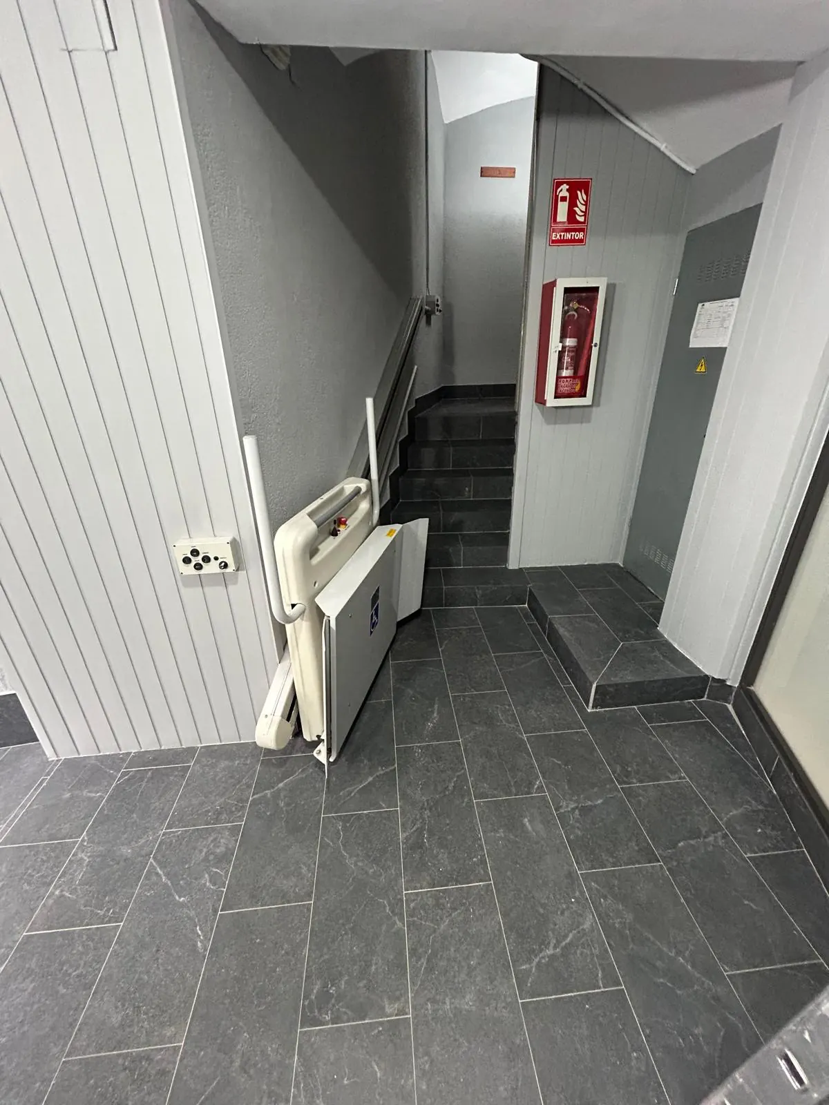 Escalera de vecinos con pavimento, barandilla y pintura renovados